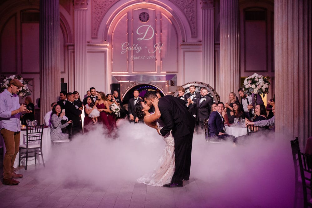 bride and groom kissing on dance floor after first dance at The Treasury On The Plaza