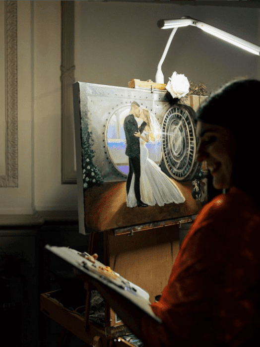 An artist doing a live painting at a wedding