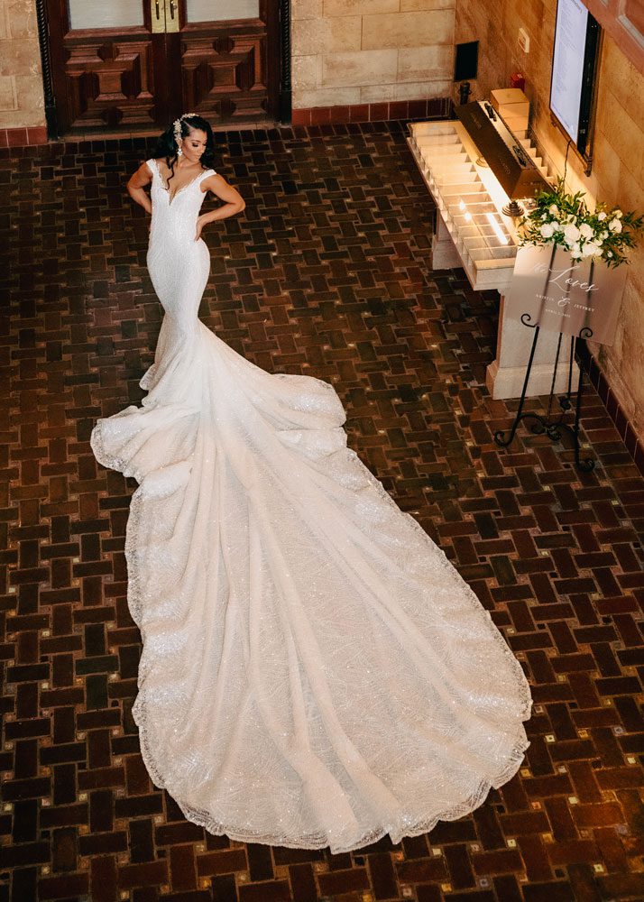 Bride showing off the long train on her wedding dress during wedding at the Treasury on the Plaza