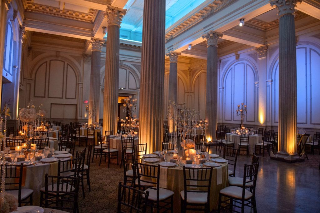White and gold linens are used for the wedding reception held in the same ballroom as the ceremony.