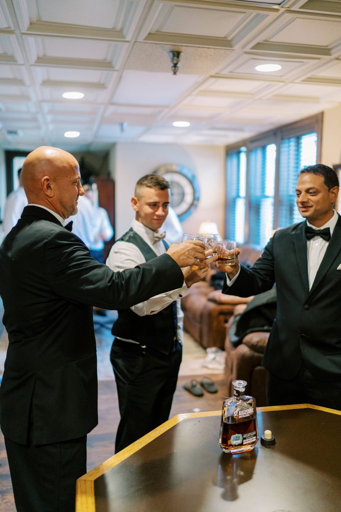 Groomsmen get ready for wedding in private suite