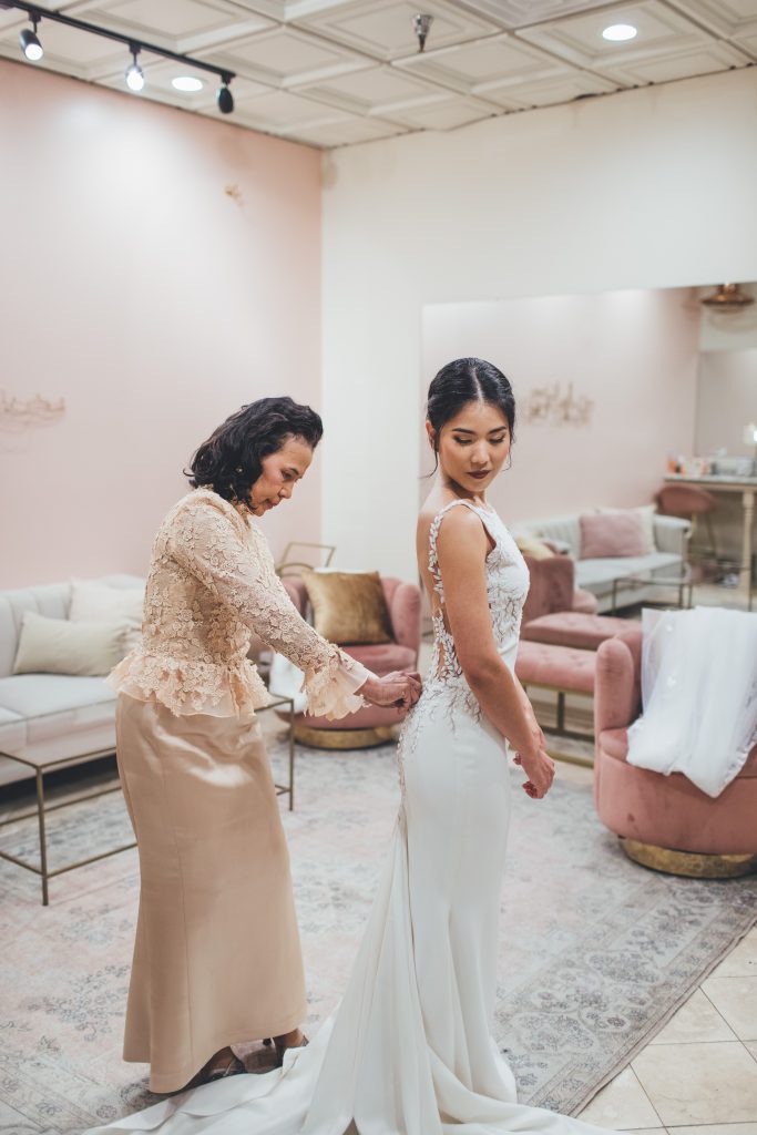 Bride gets ready in pink suite for wedding day