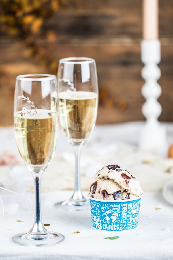 Ben & Jerry's ice cream next to two champagne glasses