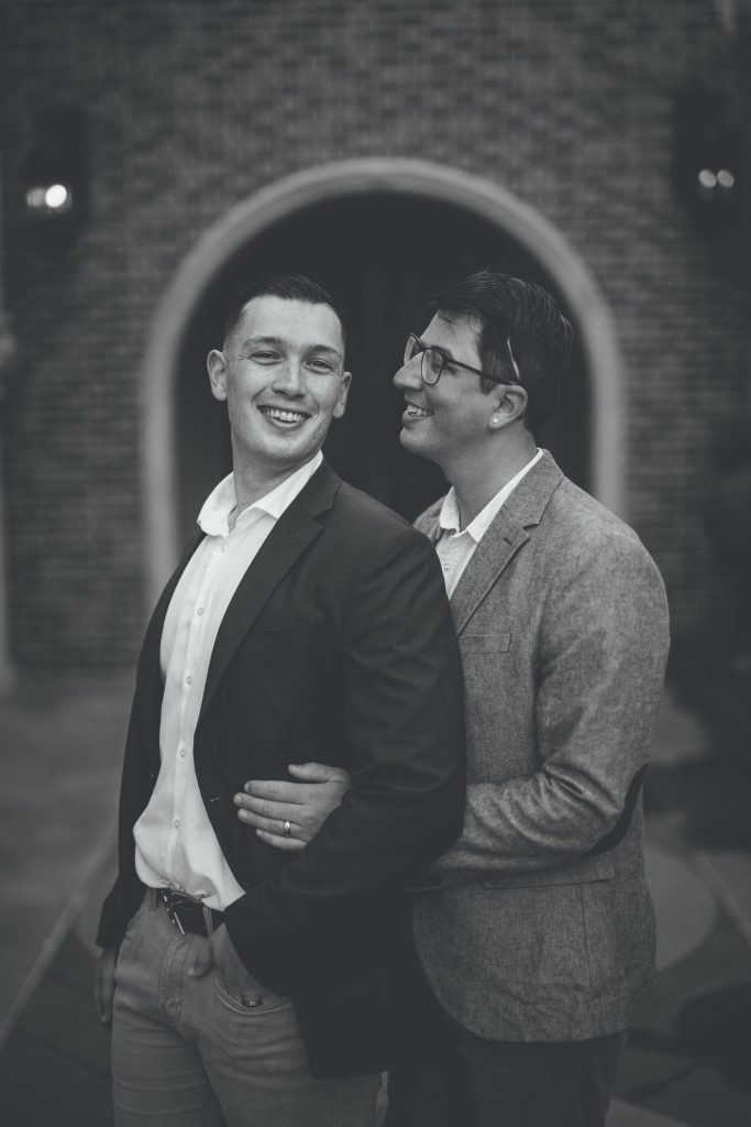 black and white engagement photo of two men