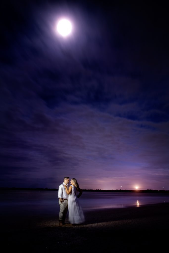 engaged couple on St. Augustine beach at night