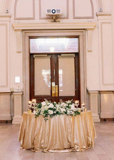 sweetheart table with gold tablecloth