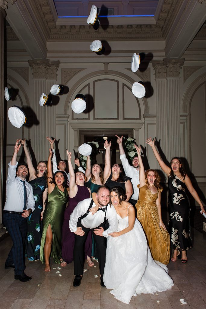 guests throwing hats into the air