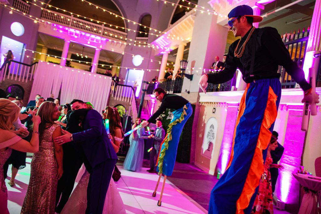 two men on stilts performing at wedding