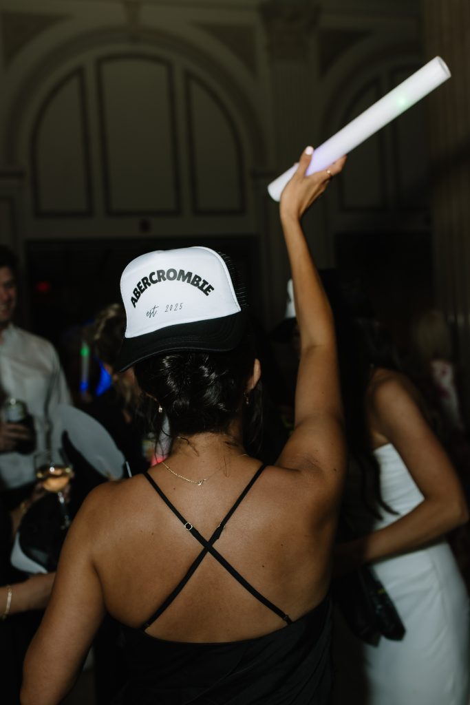 wedding guest wearing customized hat on the dance floor