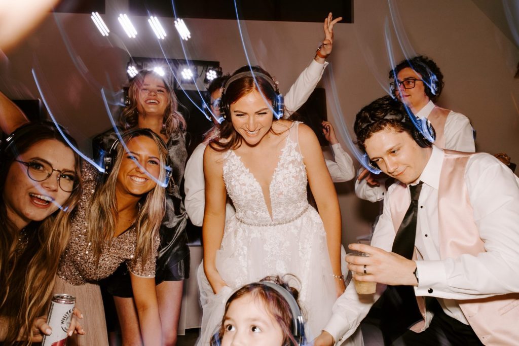 Bride and guests wearing headphones for silent disco