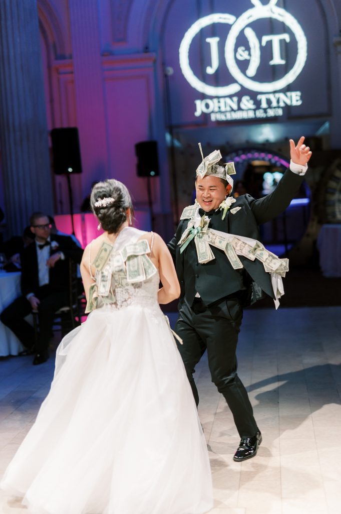 Asian bride and groom doing a money dance