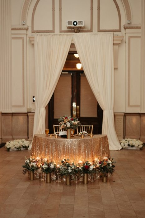 Floral arrangements surround the sweetheart table