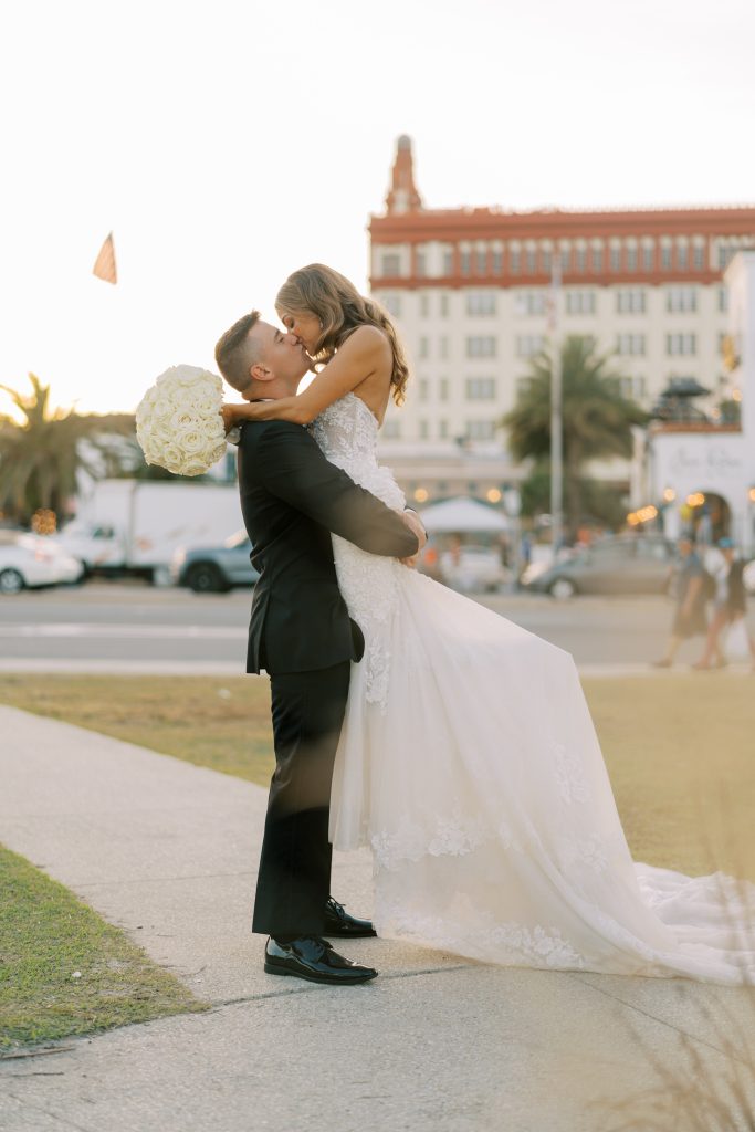 Groom lifting and kissing bride in St. Augustine