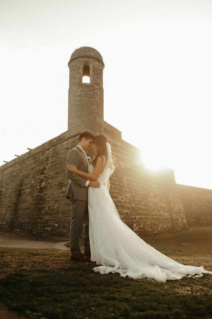 bride and groom in front of the Castillo de San Marcos in St. Augustine FL.