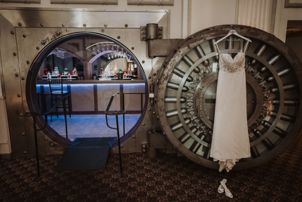 Lara's wedding dress hanging from the Vault door