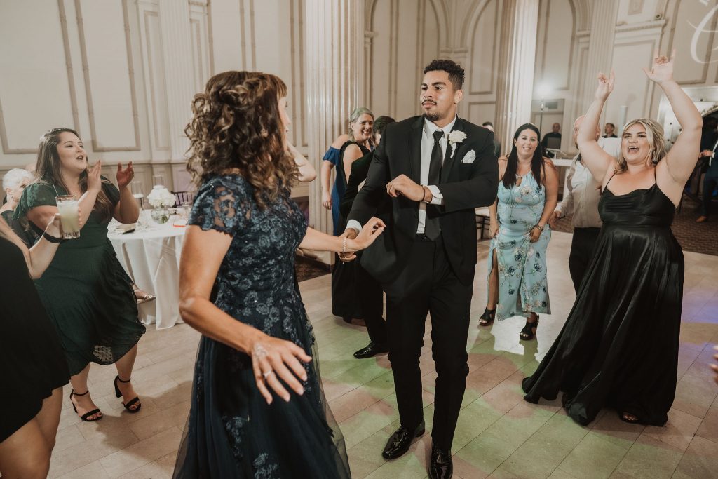 groom and mom dancing at wedding