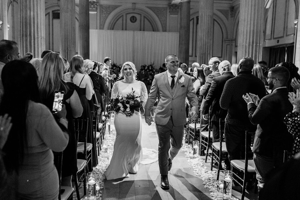 Jess and Matt walk down the aisle after saying "I do"