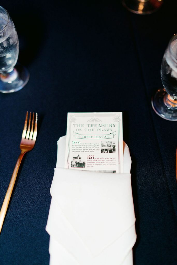 card tucked into napkin with history of the wedding venue