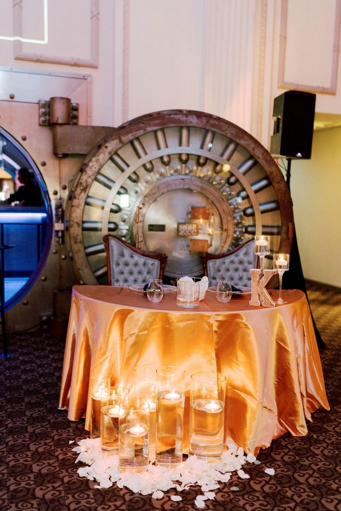 Sweetheart table in front of the open vault door