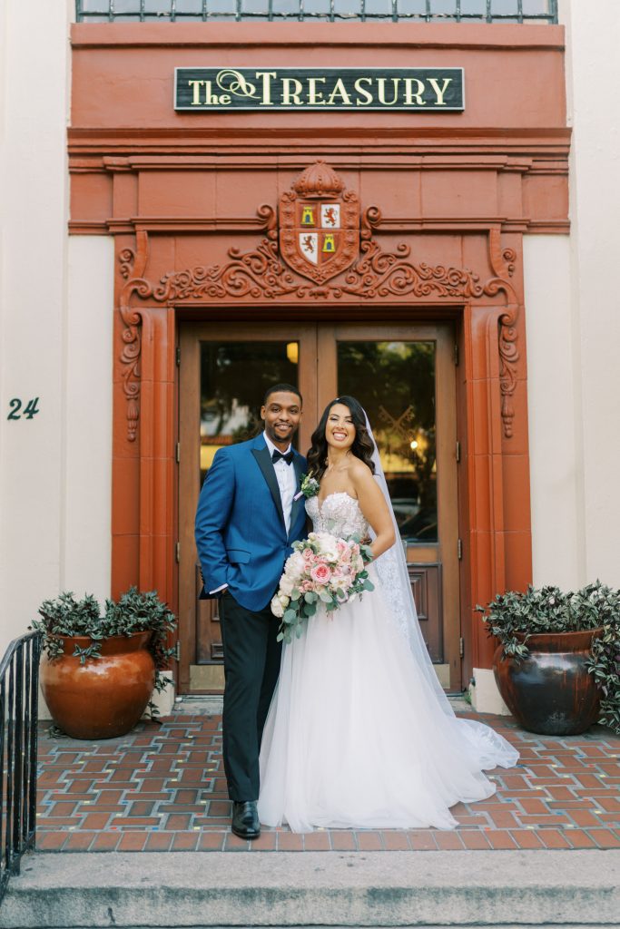 Sarah and Kevin in front of the door at Treasury on the Plaza