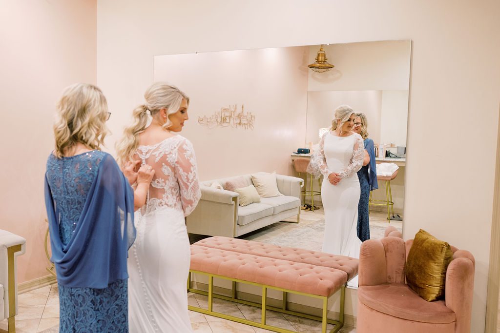 Jess being helped into her wedding dress by her mom