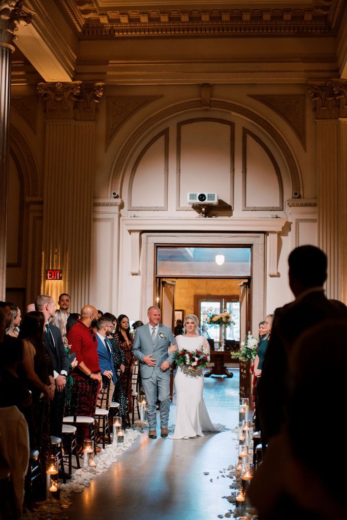 Bride Jess walking down the aisle with her father