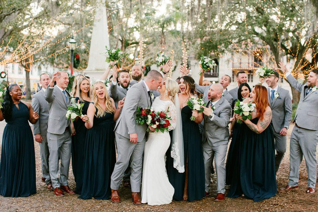 Jess and Matt kiss while wedding party celebrates