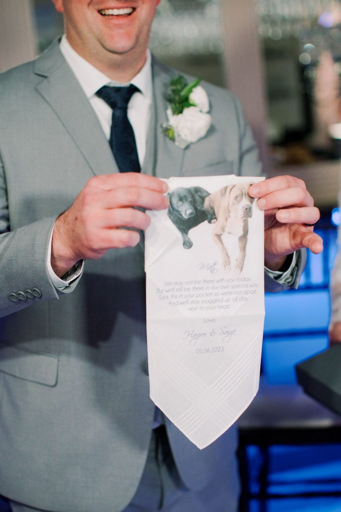 Matt holding up custom handkerchief with message from their dogs