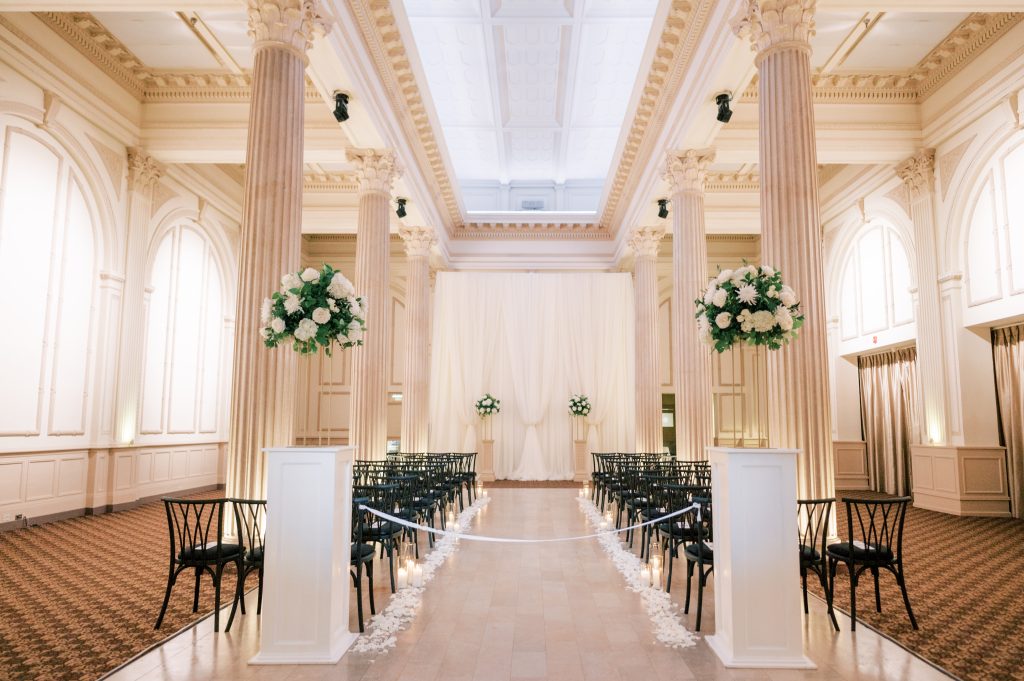 wedding ceremony aisle lined with white flower petals