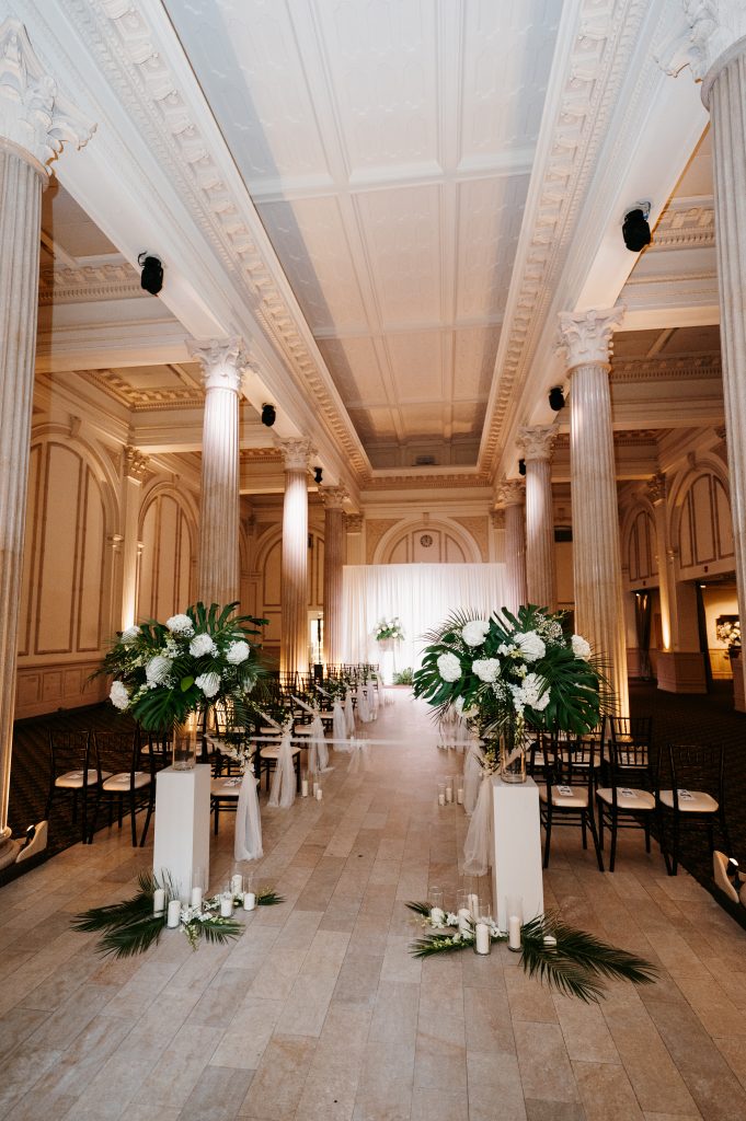 wedding aisle with fabric drapes on chairs