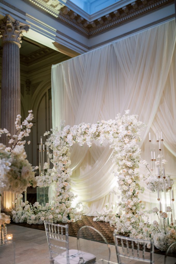 wedding ceremony arch covered in white flowers