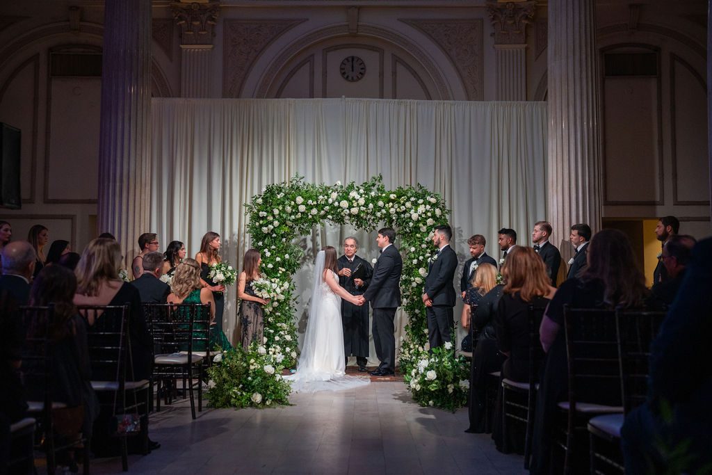 Grace and Robert's greenery and floral arch at their ceremony