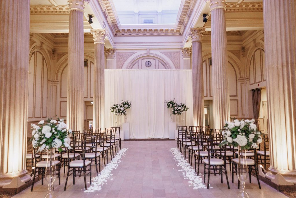 Wedding aisle lined with scattered white rose petals