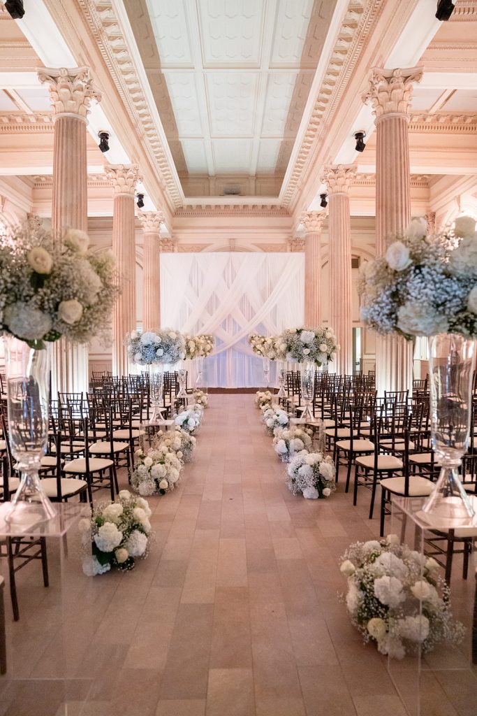 tall flower arrangements as wedding aisle decor