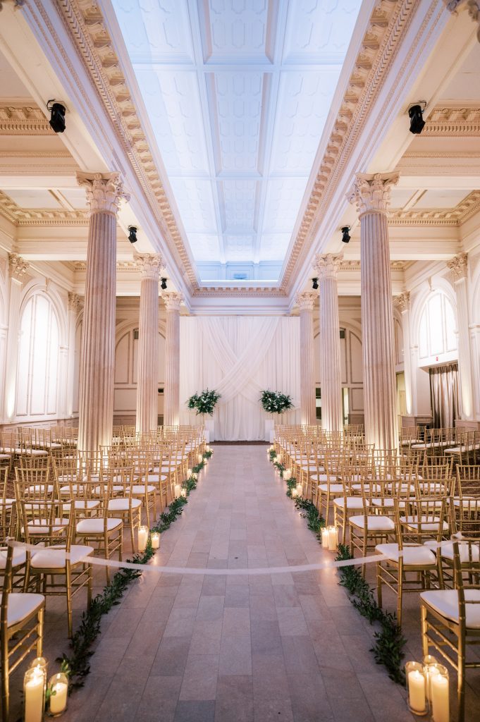 greenery lining wedding aisle at Treasury on the Plaza