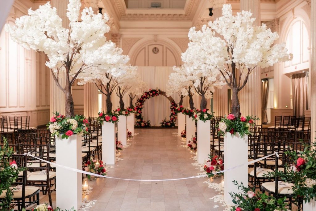 wedding aisle lined with decorative trees