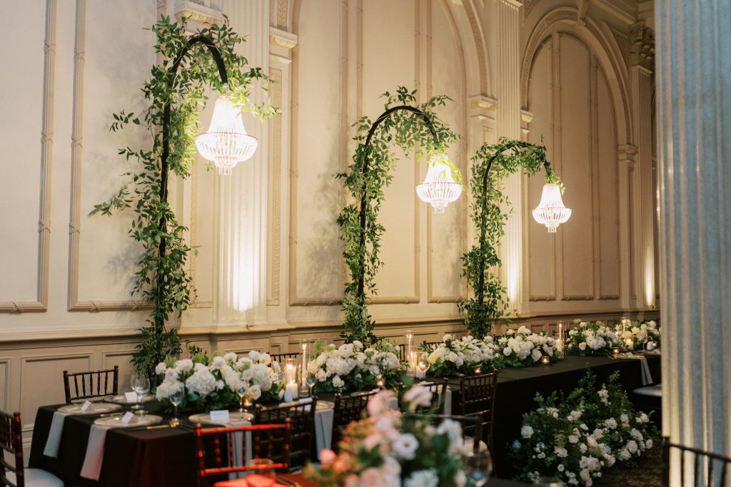 freestanding chandeliers over tables at wedding reception