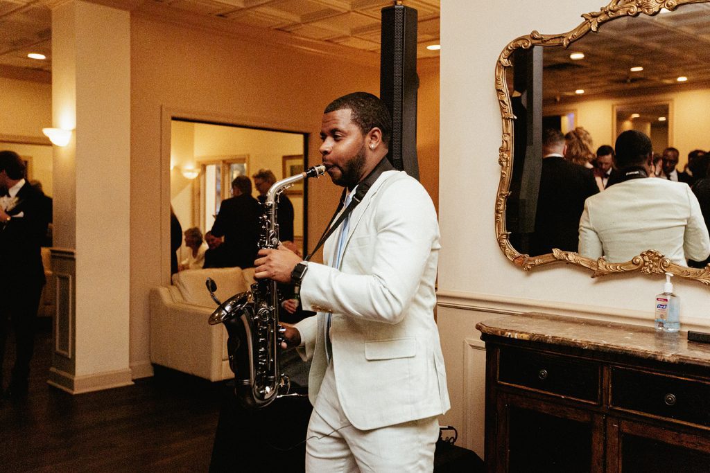 Saxophonist performing during cocktail hour