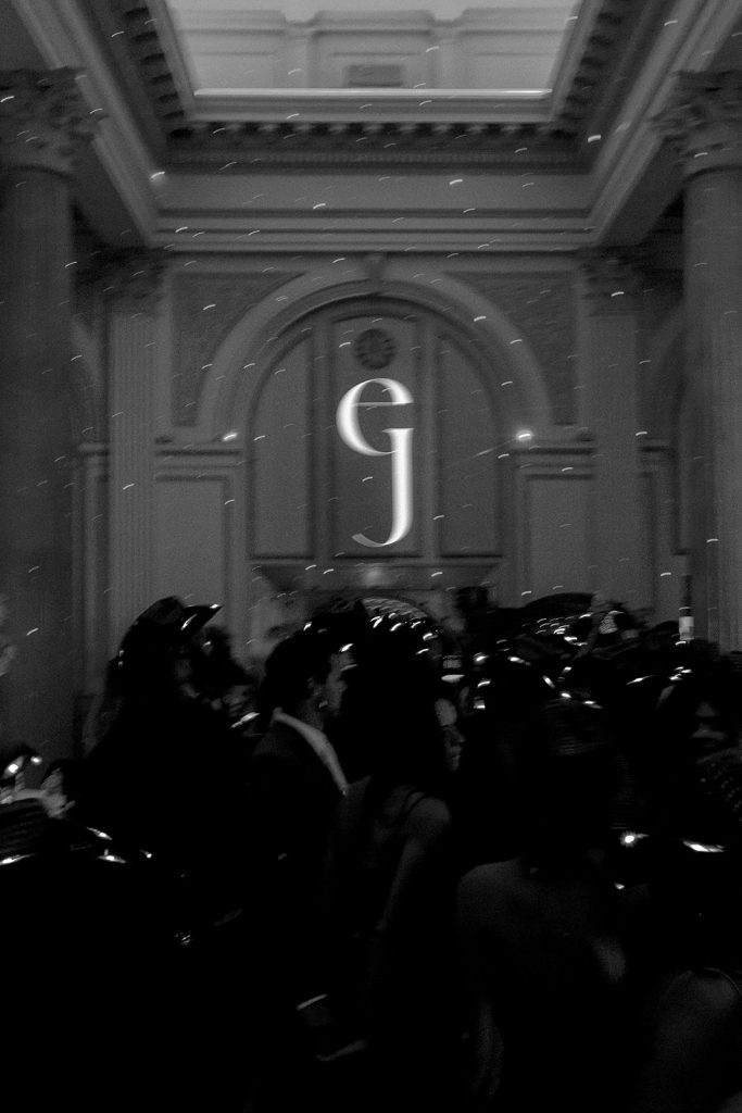 black and white photo of custom monogram for couple projected onto wall