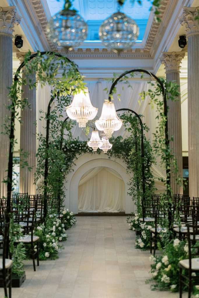 wedding aisle lined with freestanding chandeliers
