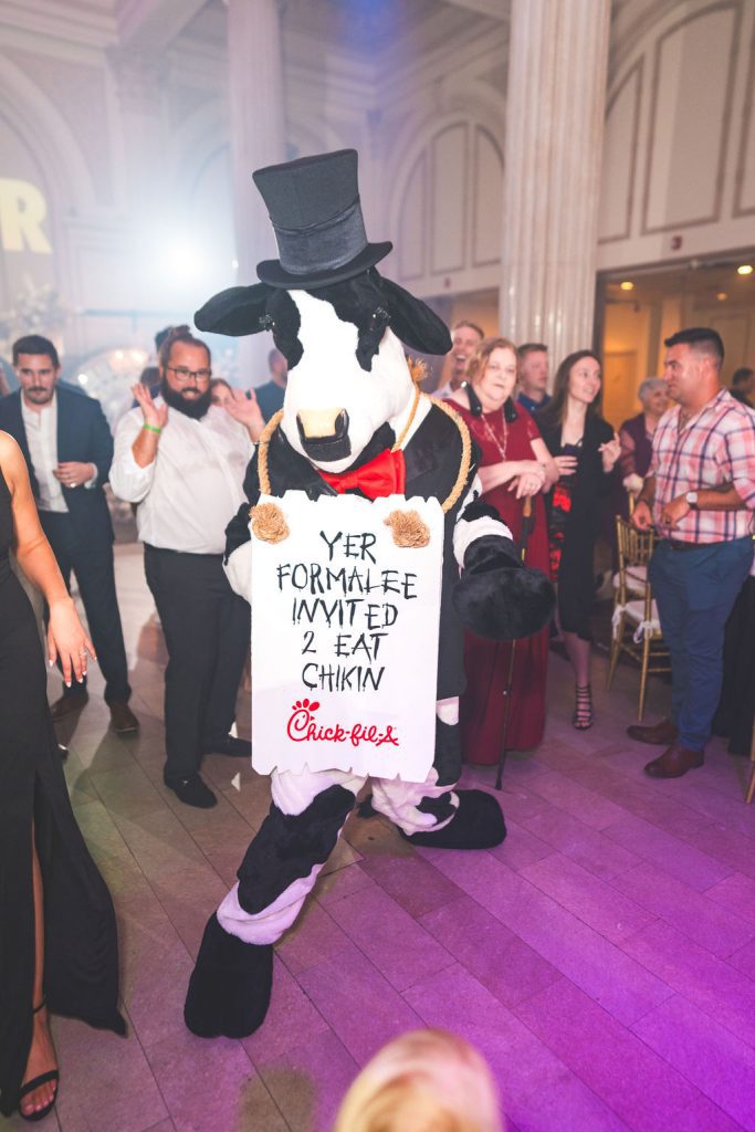 Chick-Fil-A cow mascot in tux at wedding
