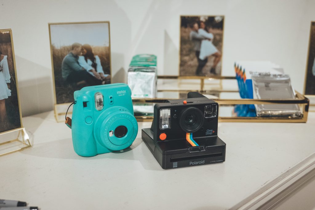 Polaroid and instant camera on table at wedding