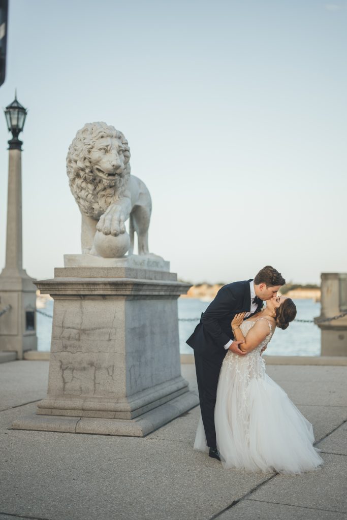 Groom dipping bride into a kiss at the Bridge of Lions in St. Augustine