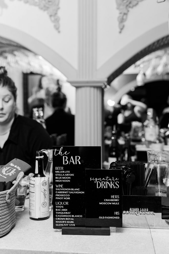 black and white photo of bar sign at wedding