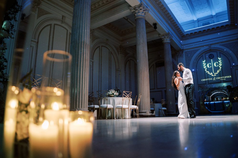 Bride and groom dance during wedding reception at The Treasury on the Plaza