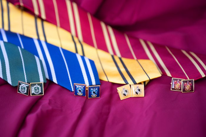 Ties in house colors and cufflinks with house emblems are a subtle way to incorporate your Harry Potter-theme into your wedding attire. | Photo: Life & Love Studio