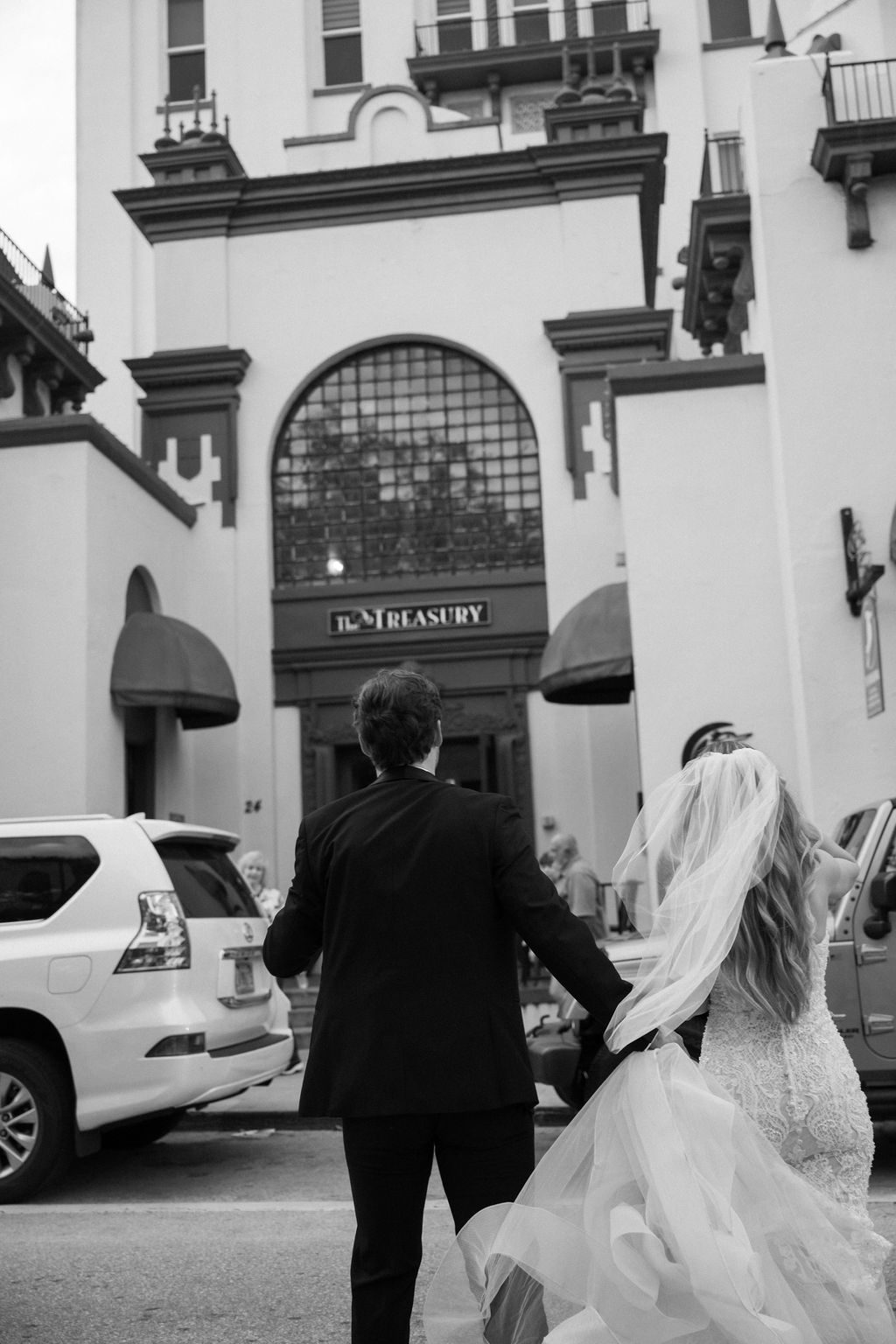 couple entering treasury on the plaza for wedding