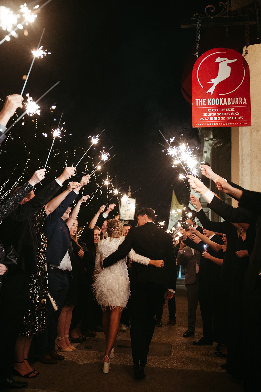newlyweds under sparklers from guests at treasury on the plaza