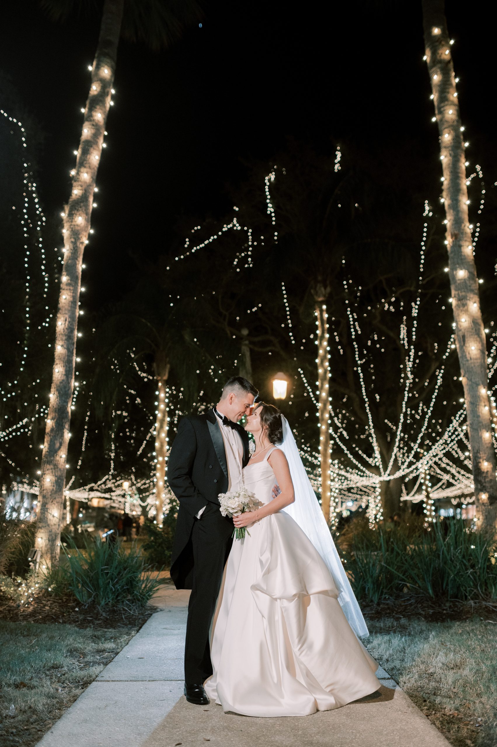 newlyweds kissing outside treasury on the plaza
