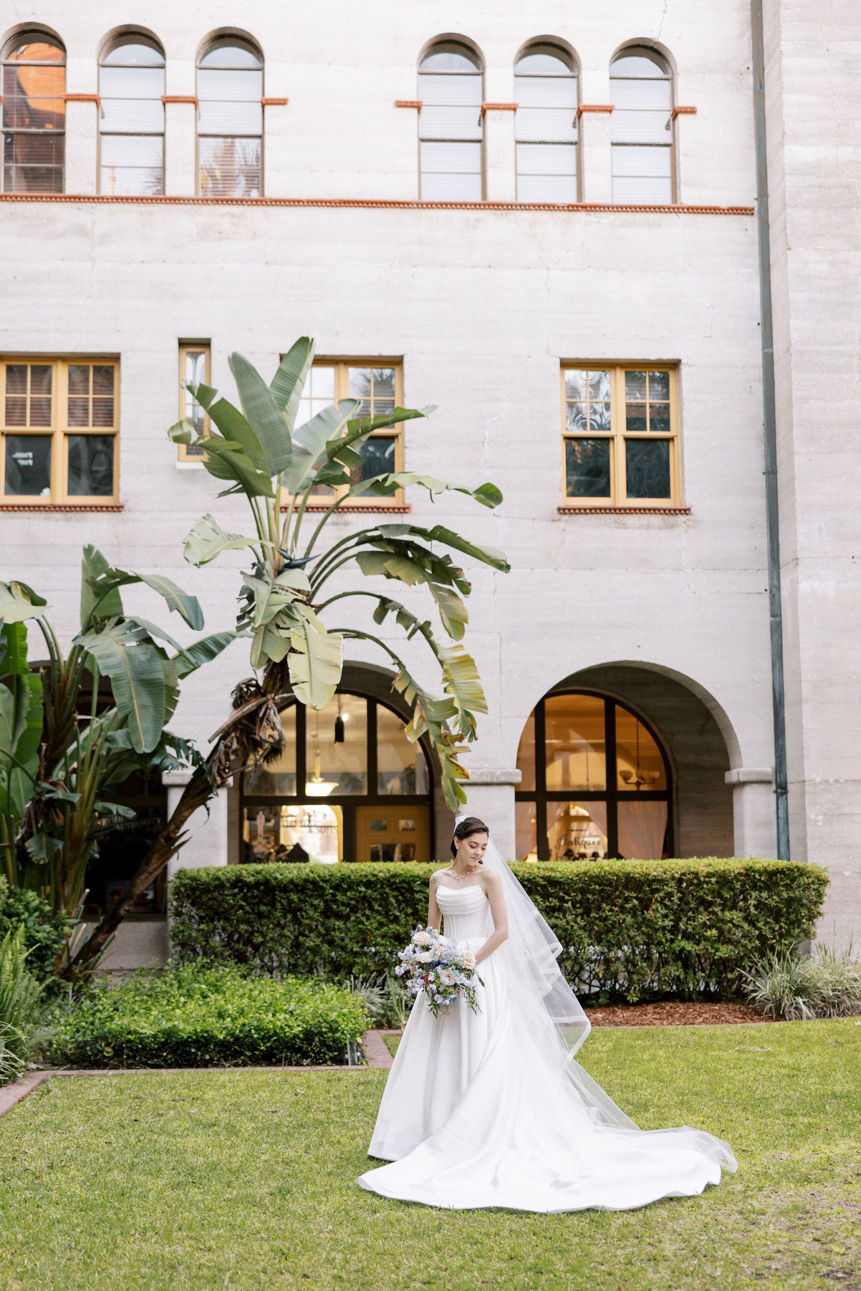 Arianna showing off her gorgeous wedding dress in the central courtyard of the Lightner Museum. | Photo: Eli Meyer Studio